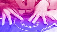 A seamstress stitching starts on a European flag patch in Budapest, April 2003