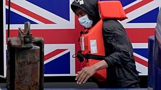 FILE - A man thought to be a migrant disembarks after being picked up in the Channel by a British border force vessel in Dover, south east England, 13 August, 2021.