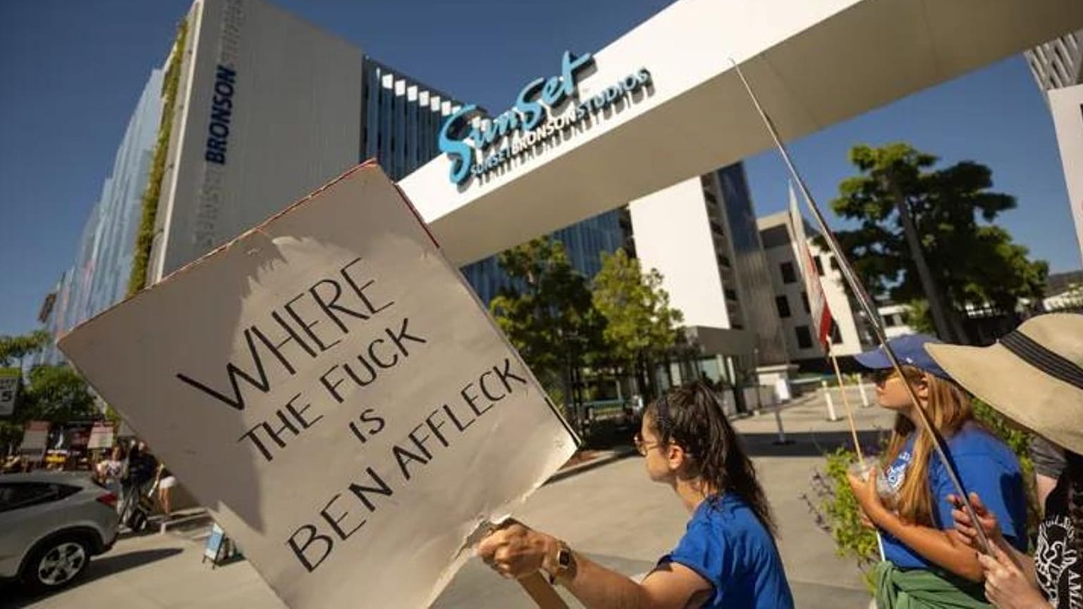 A demonstrator striking with WGA and SAG-AFTRA members