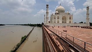 The Taj Mahal on the banks of the Yamuna river, India.