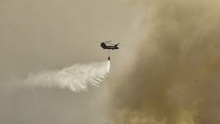 A military Chinook helicopter flies over the area of Magoula, 25 km southwest of Athens on July 18, 2023