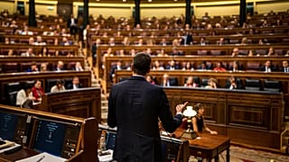 rime Minister Pedro Sánchez, center, gives a reply to United Podemos (United We Can) party leader Pablo Iglesias during the parliamentary debate at the Spanish parliament.
