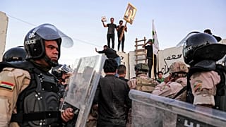 Iraqi riot police try to disperse supporters of Iraqi Shiite cleric Moqtada al-Sadr gathering for a protest outside the Swedish embassy in Baghdad on July 20, 2023.