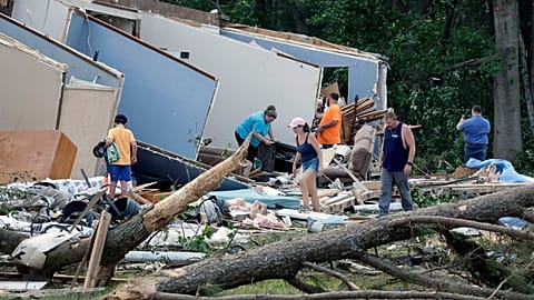 People survey the damage to their home that was destroyed by a tornado on Wednesday, July 19, 2023, in Dortches, NC.