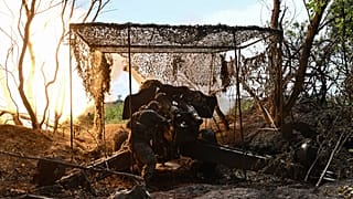 A Ukrainian artilleryman fires a 152 mm towed gun-howitzer D-20 at Russian positions on the front line near Bakhmut, eastern Ukraine, on July 20, 2023.