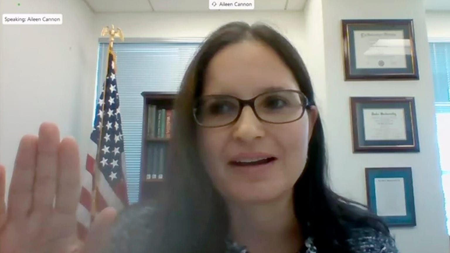 In this image provided by the U.S. Senate, Aileen M. Cannon raises her hand after being sworn in to testify remotely during a Senate Judiciary Committee