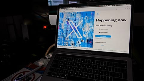 A view of a lap top showing the Twitter signing in page displaying the new logo