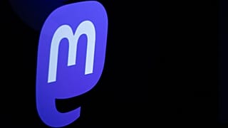 The logo of Mastodon reflected on a smartphone screen