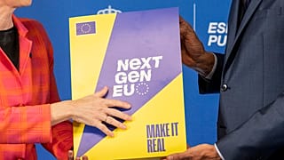 EU Commission President Ursula von der Leyen, left, and Spain's Prime Minister Pedro Sanchez hold the Next Gen EU agreement