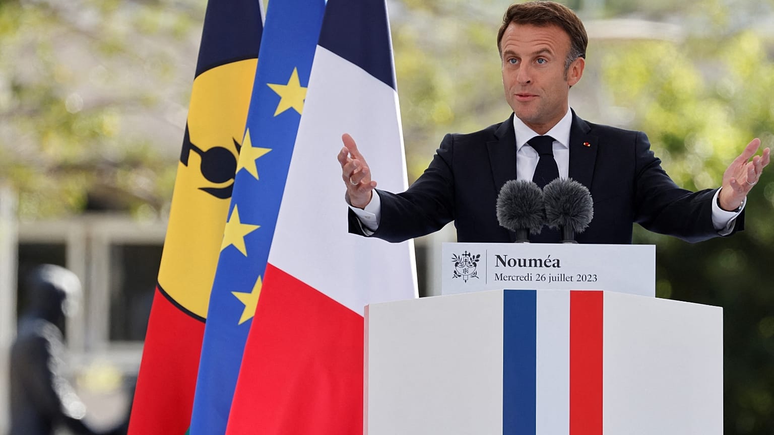French President Emmanuel Macron delivers his speech at the Place des Cocotiers in Noumea on July 26, 2023.