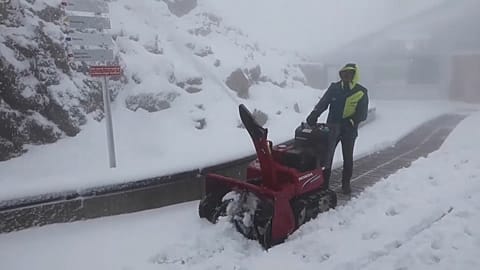 Un hombre despeja la nieve caída este miércoles 26 de julio, en la cima del Nebelhorn, en los Alpes bávaros