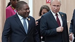 Russian President Vladimir Putin, right, and Mozambique President Filipe Nyusi arrive for a meeting on the sidelines of the Russia-Africa Summit