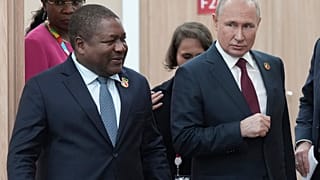 Russian President Vladimir Putin, right, and Mozambique President Filipe Nyusi arrive for a meeting on the sidelines of the Russia-Africa Summit
