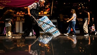 A man pushes a trolley with bottles of water on a hot summer day, in Istanbul, Turkey, July 13, 2023.