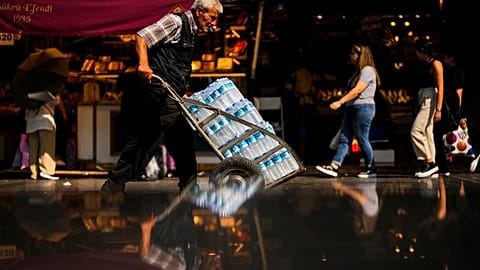 A man pushes a trolley with bottles of water on a hot summer day, in Istanbul, Turkey, July 13, 2023.
