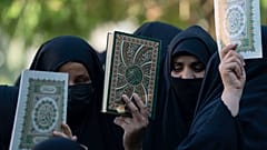 Iraqis raise copies of the Quran, Muslims' holy book, during a protest in Baghdad, Iraq, Saturday, July 22, 2023