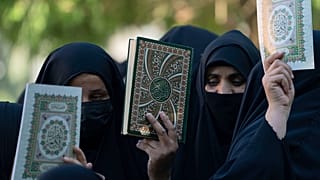 Iraqis raise copies of the Quran, Muslims' holy book, during a protest in Baghdad, Iraq, Saturday, July 22, 2023