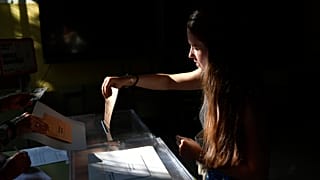 A woman casts her vote at a polling station in Pamplona, Spain, Sunday July 23, 2023.