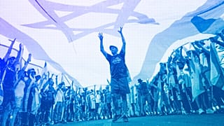 Demonstrators wave large Israeli flag during a protest against plans by PM Benjamin Netanyahu to overhaul the judicial system, outside the Knesset in Jerusalem, July 2023