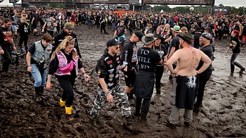 Metal fans wait at one of the entrances for the festival grounds to open in Wacken, Germany