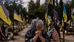 Svitlana Sushko, 62, sobs while visiting the grave of her youngest son, a Ukrainian soldier who was killed last year in the war against Russia, in Kyiv.