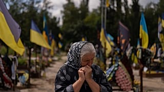 Svitlana Sushko, 62, sobs while visiting the grave of her youngest son, a Ukrainian soldier who was killed last year in the war against Russia, in Kyiv.