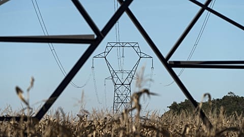Electricity poles are seen in the countryside outside Lyon, central France, Sept. 12, 2022.