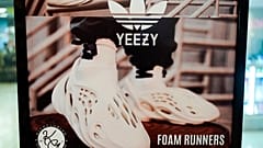 A sign advertises Yeezy shoes made by Adidas at Kickclusive, a sneaker resale store.