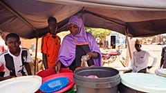 A woman prepares food in Niamey, Niger, Saturday, July 29, 2023.