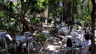 People take some shade in Naples' Palazzo Venezia