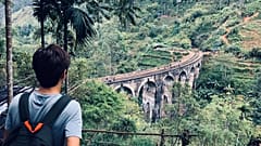 A walker looks over the Nine Arch Bridge, Sri Lanka. 