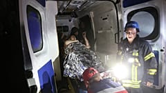 Socorristas transportam uma pessoa ferida na sequência dos ataques a Pokrovsk para dentro de uma ambulância, Donetsk, Ucrânia