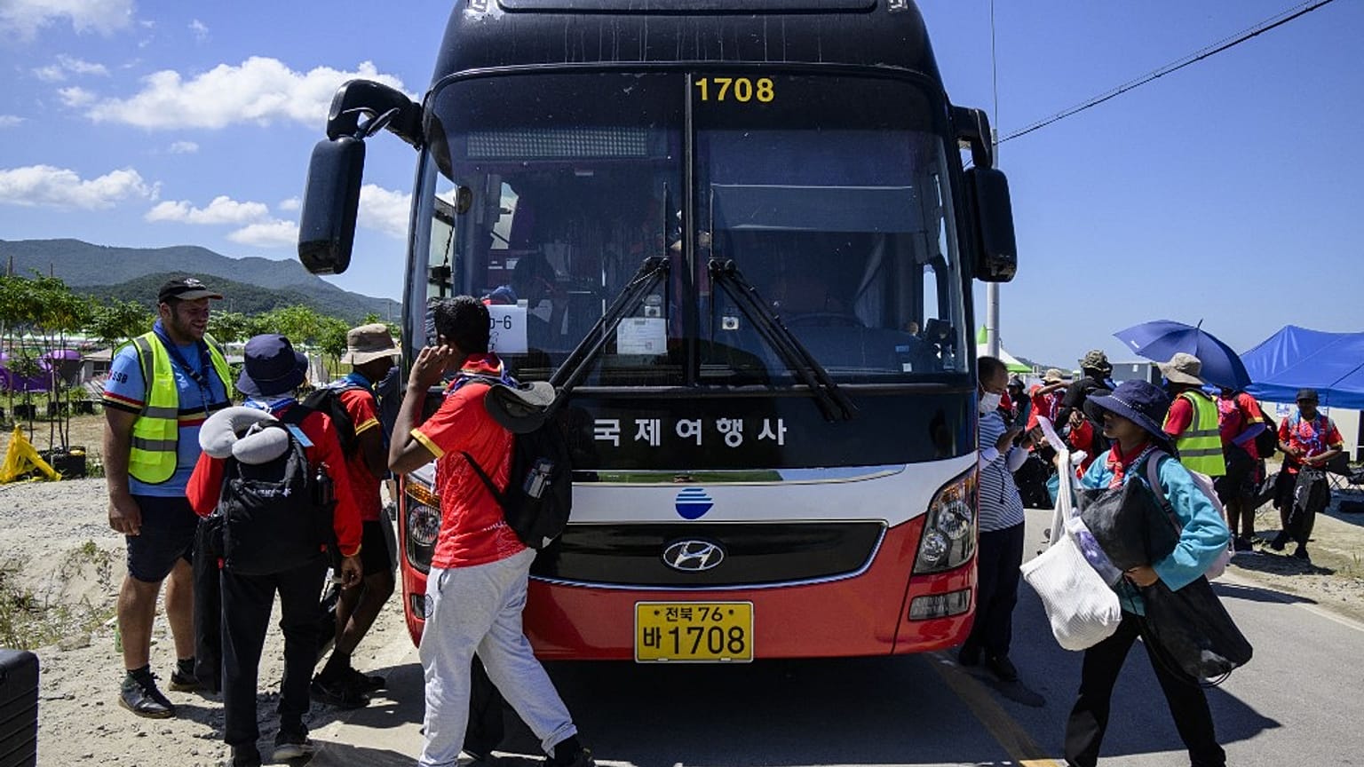 Les scouts se préparent à monter à bord d'un autocar lors des préparatifs pour quitter le Jamboree scout mondial à Buan, dans la province du Jeolla du Nord (8 août 2023). 