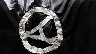 FILE - Anarchist supporters are seen through an anarchist flag during a rally marking the International May Day on May 1, 2009. 