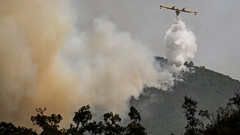 A Canadair amphibious aircraft drops water over a wildfire in Reguengo, Portalegre district, south of Portugal, on August 8, 2023. 