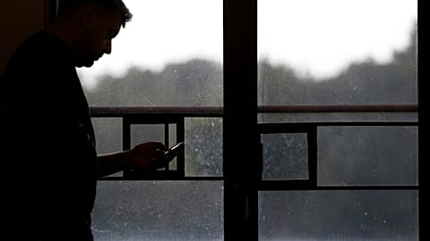 A person downloading music on his phone.