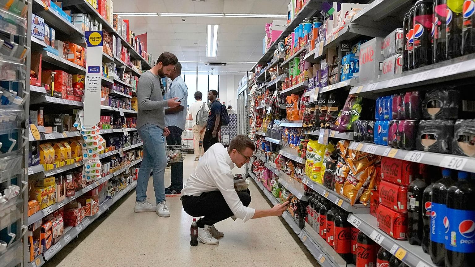 Shoppers buy food in a supermarket in London, Wednesday, Aug. 17, 2022.