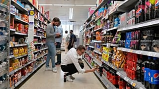 Shoppers buy food in a supermarket in London, Wednesday, Aug. 17, 2022.