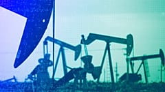 Pumpjacks work in a field near Lovington, NM, April 2015