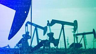 Pumpjacks work in a field near Lovington, NM, April 2015