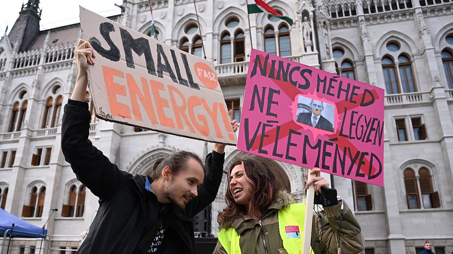 People hold up a placard reading "If you don't have the uterus, don't comment"(R) at a protest in front of the parliament building in Budapest, Hungary on September 28, 2022.