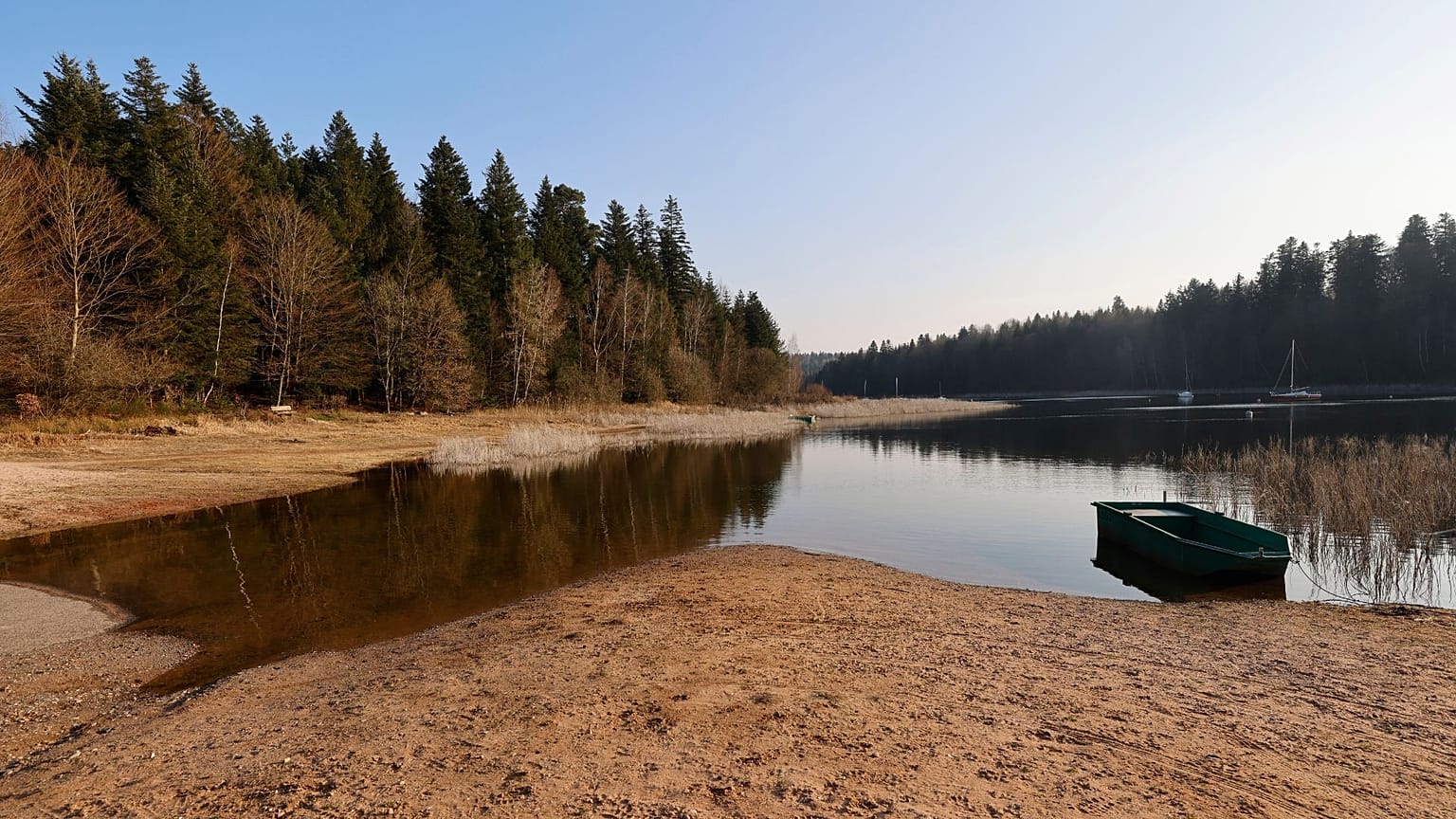 A small boat floats on the the Pierre-Percee lake, eastern France, Wednesday, March 1, 2023.