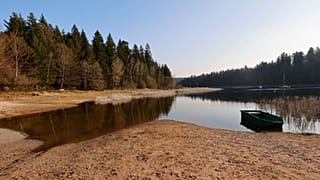 A small boat floats on the the Pierre-Percee lake, eastern France, Wednesday, March 1, 2023.