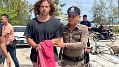 A Thai police officer escorts Spanish Daniel Sancho Bronchalo on suspicion of murdering and dismembering a Colombian surgeon from Koh Phagnan island to Koh Samui Island court.