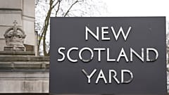 FILE: A sign outside New Scotland Yard, the headquarters of the London Metropolitan Police, in London, Tuesday, March 21, 2023.