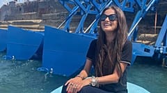 Inna Braverman sits infront of the Eco Wave Power station installed in Israel. 