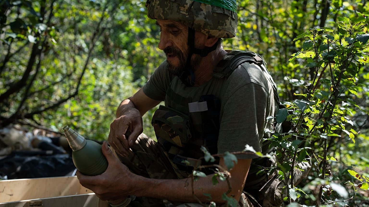 A Ukrainian soldier prepares a mortar shell on the frontline in the outskirts of Kreminna, Ukraine, Wednesday, Aug. 16, 2023.