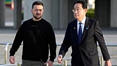 FILE: Ukrainian President Volodymyr Zelenskyy, left, is escorted by Japanese Prime Minister Fumio Kishida in Hiroshima, May 2023