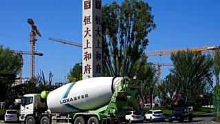 A cement truck moves past a new Evergrande housing development in Beijing on Sept. 22, 2021. 