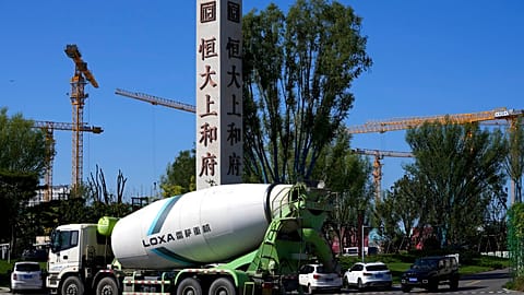 A cement truck moves past a new Evergrande housing development in Beijing on Sept. 22, 2021. 